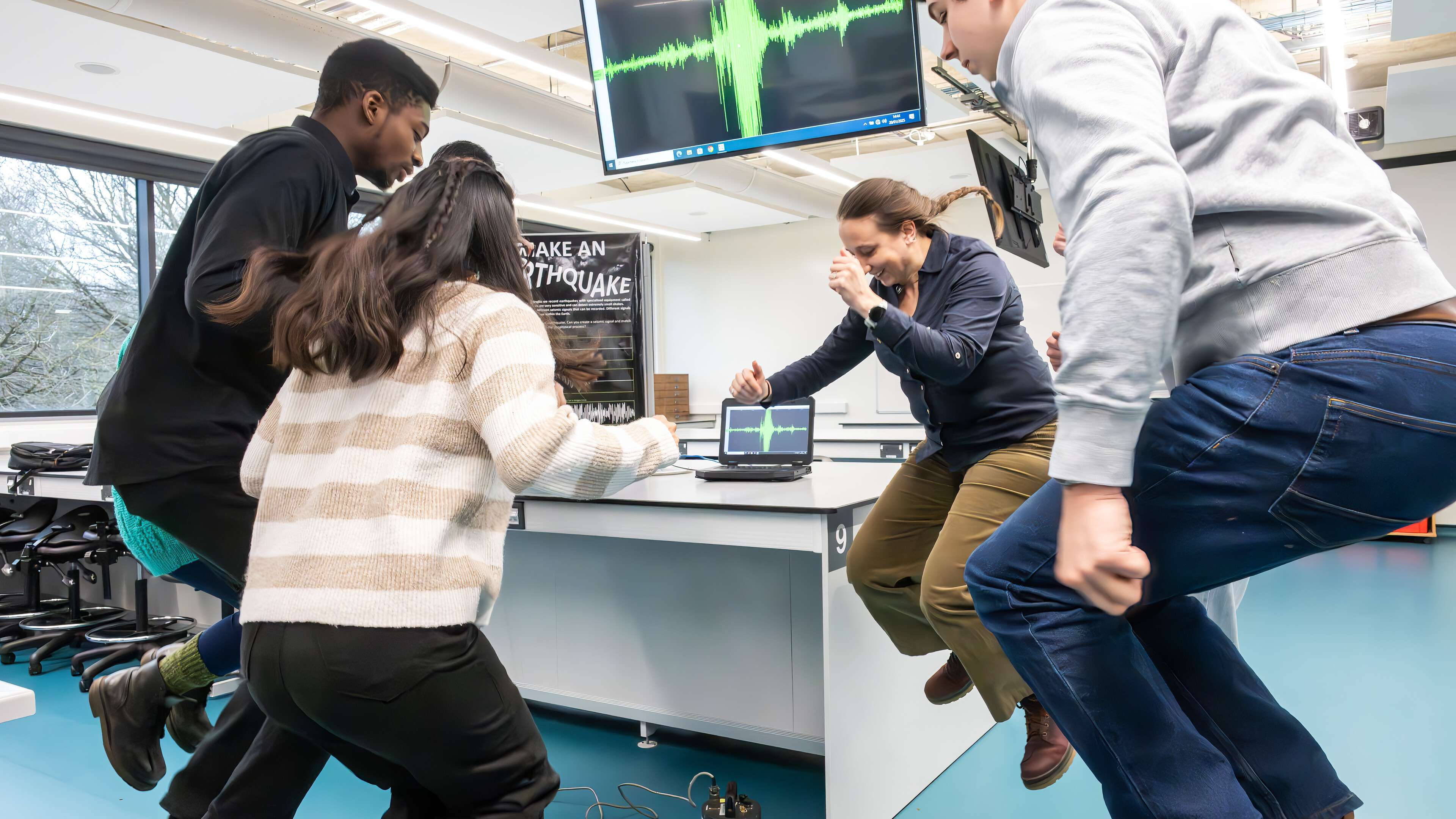 Environmental Science students jumping in a lab