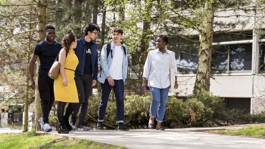 Group of students walking on campus at UEA