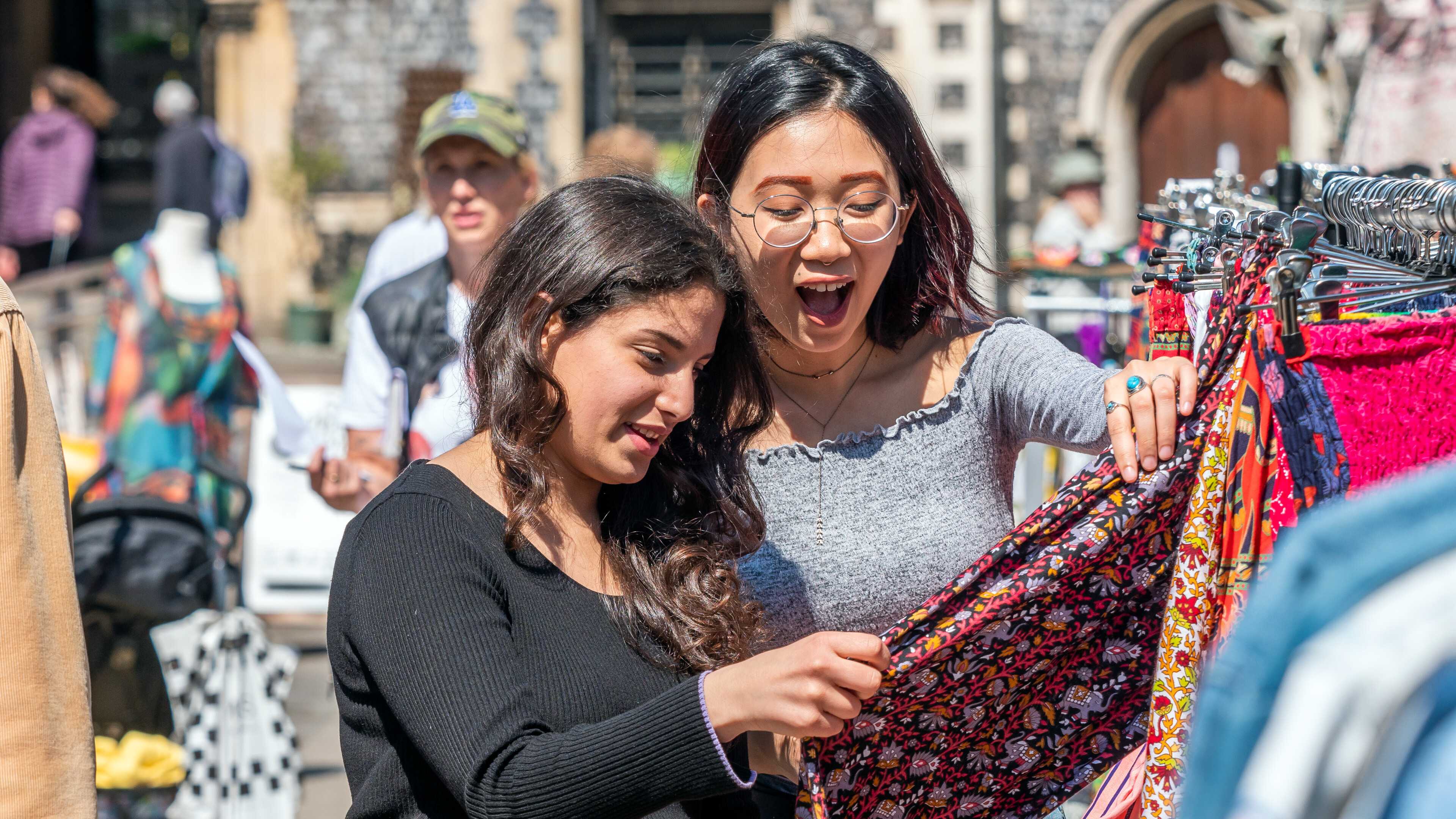 Students looking at clothes at a stall in Norwich market