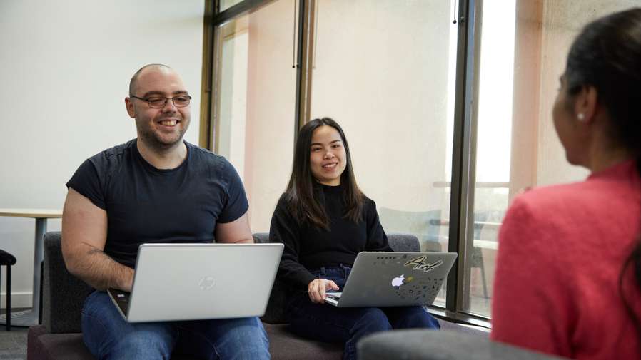 Students working with laptop in the Library