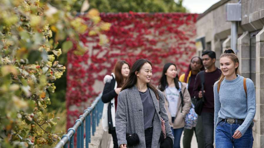 Students walking and talking on campus