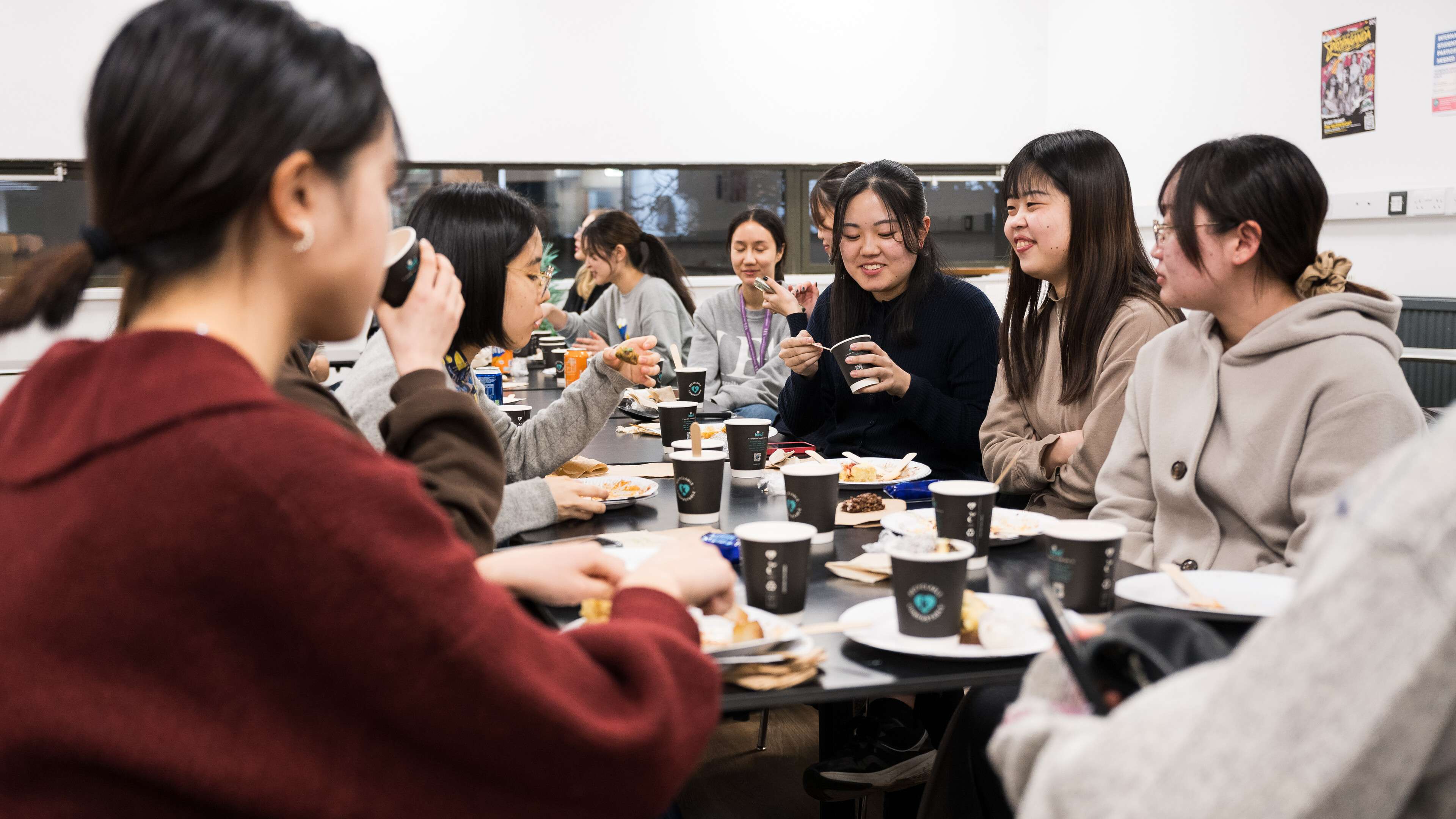Several students sitting, socialising and eating in the Warren during Study Abroad's International Food Night