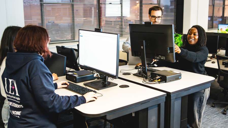 Students standing at computers
