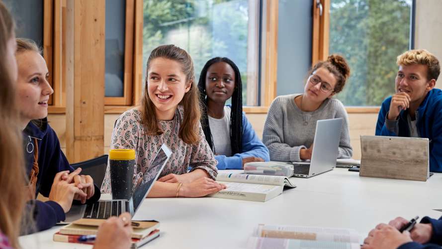 Students studying and discussing in classroom