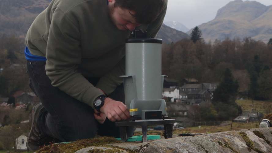 Student using Geophysics equipment outside