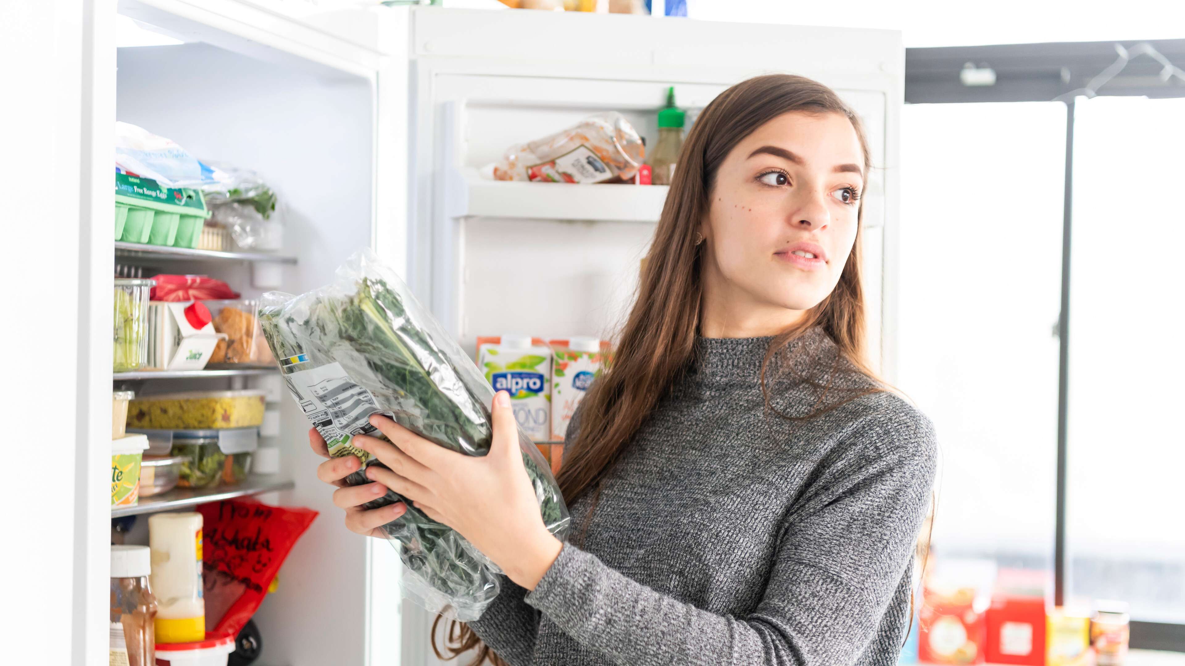 Student taking food out of fridge