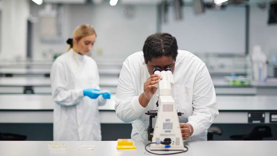 Mature students of Biology in New Science Building laboratory conducting an experiment.