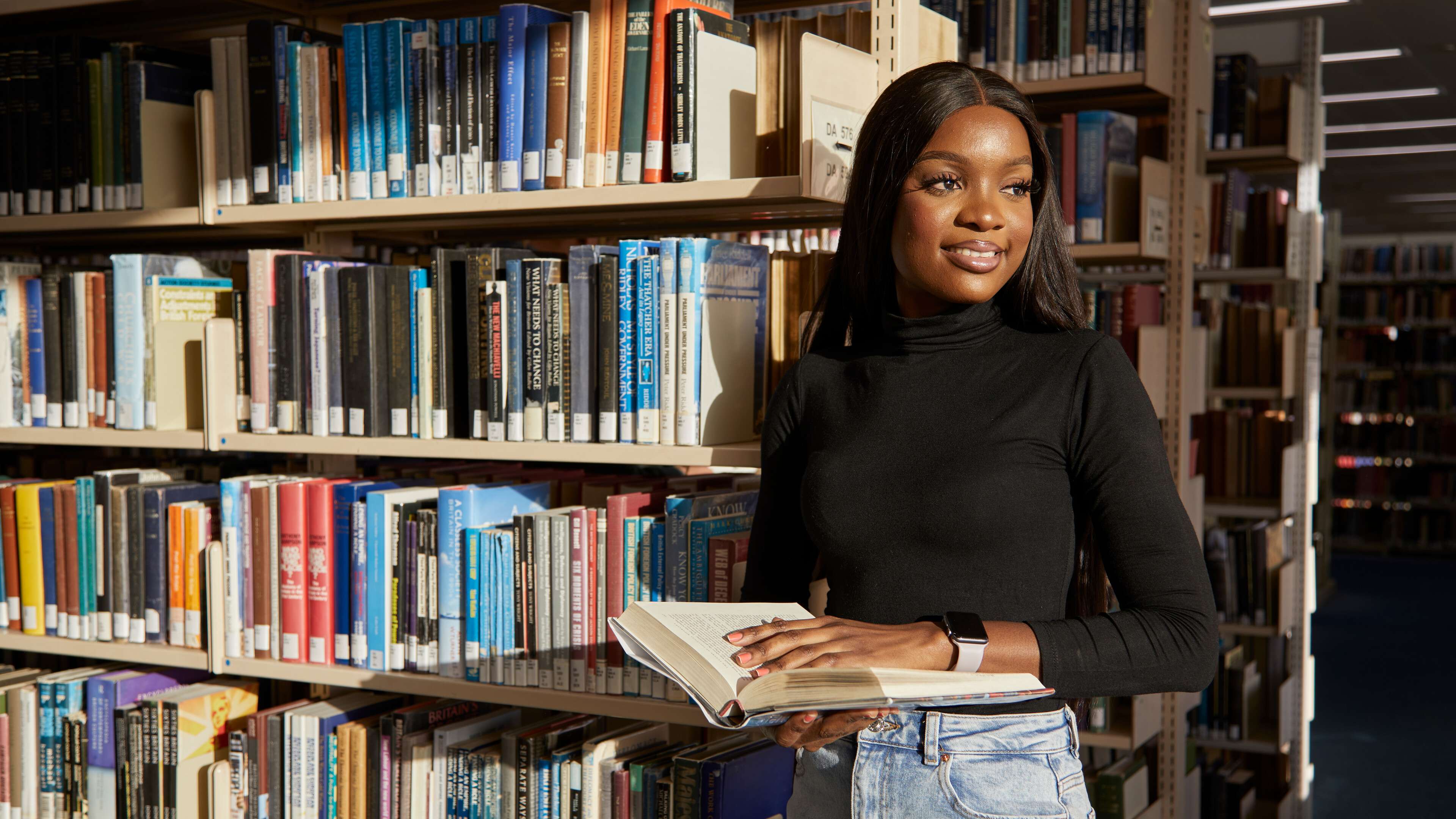 Student browsing bookshelves in the Library