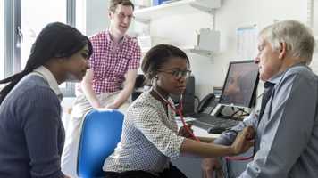 Medicine students working with patient