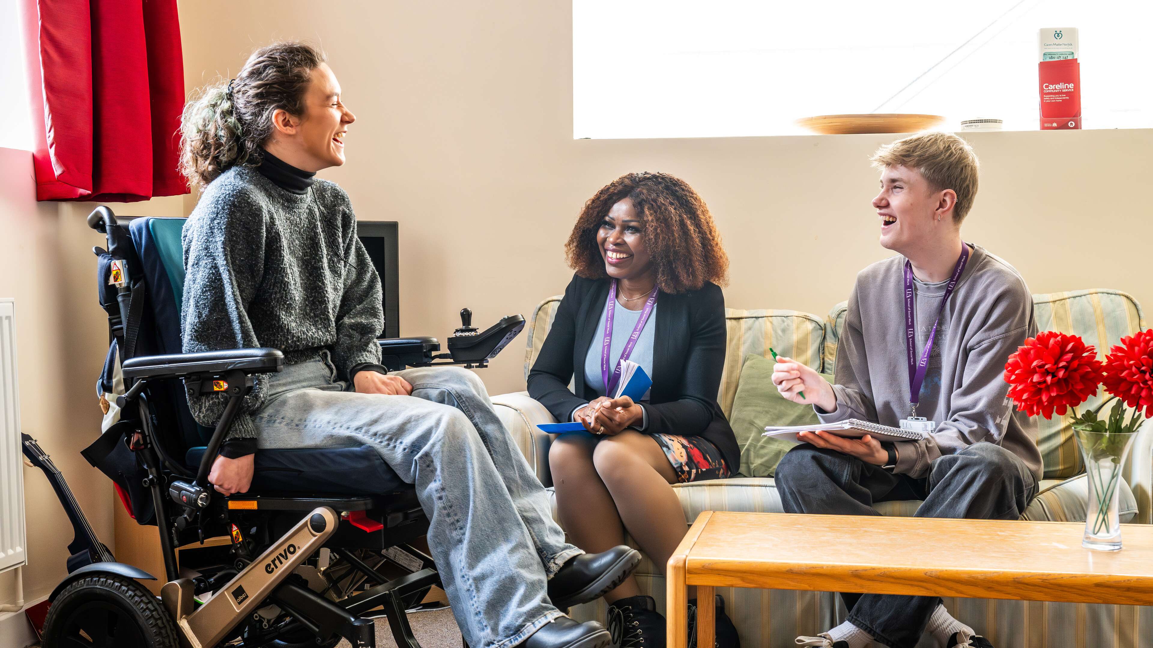Social work students in discussion with a wheelchair user