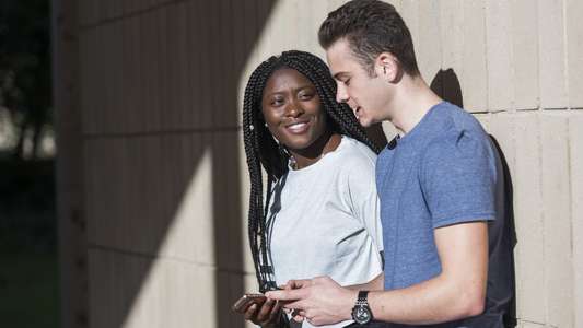 Two students chatting on UEA campus