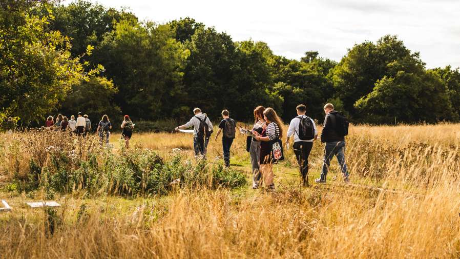Environmental science and geography students on campus, taking part in an outdoor field activity