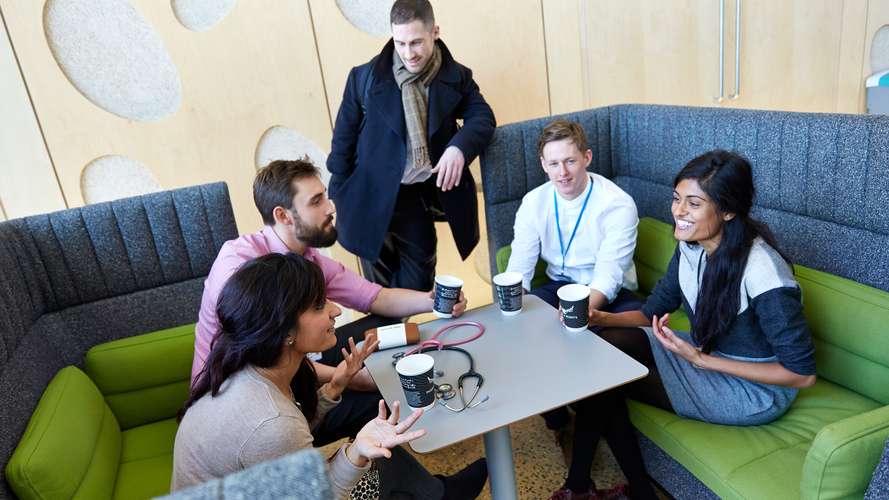 Medical students talking in the Bob Champion Building, Norwich Medical School