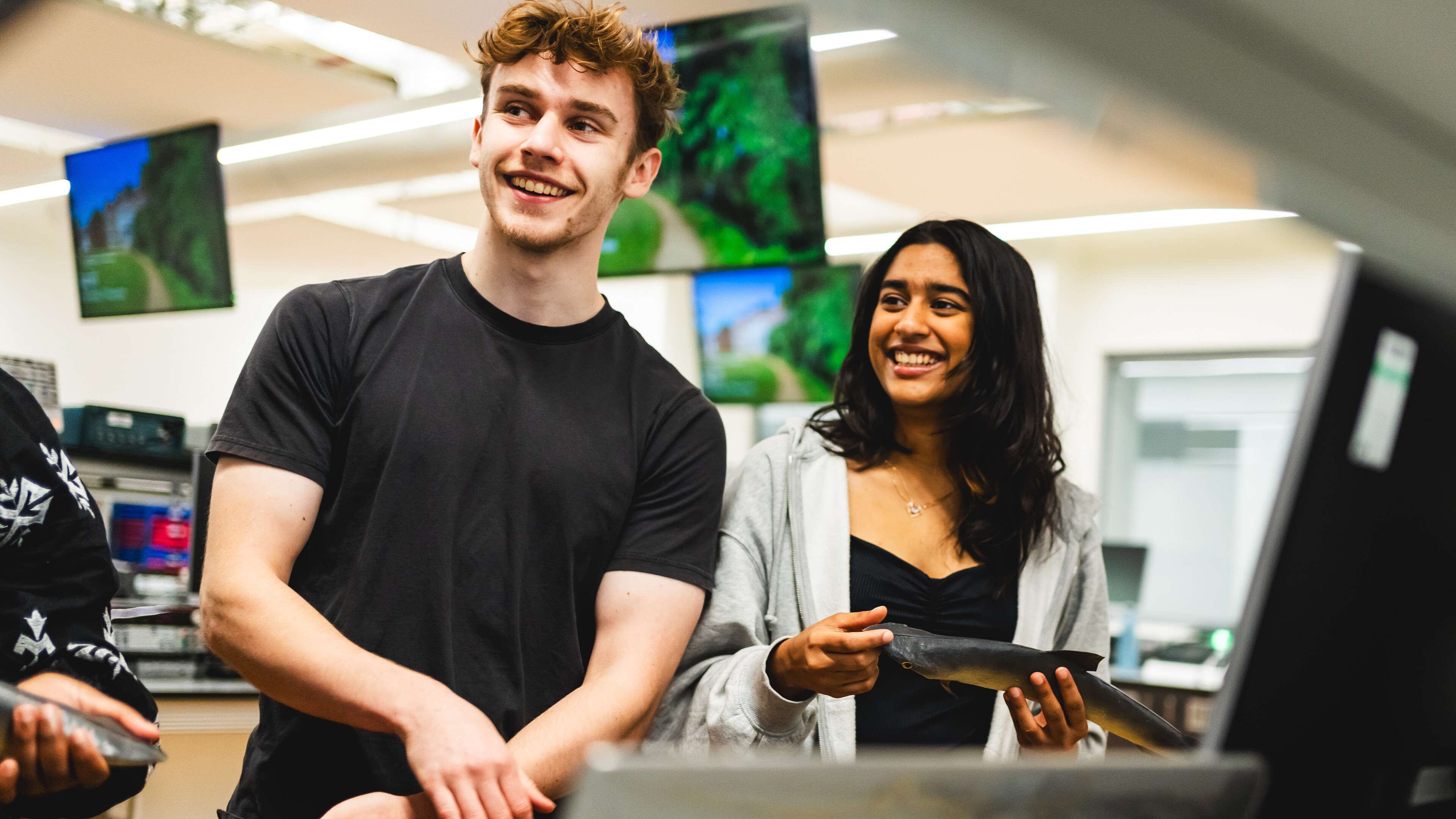 Computing Science Students are working together as part of the dark room fish project in the New Science Building
