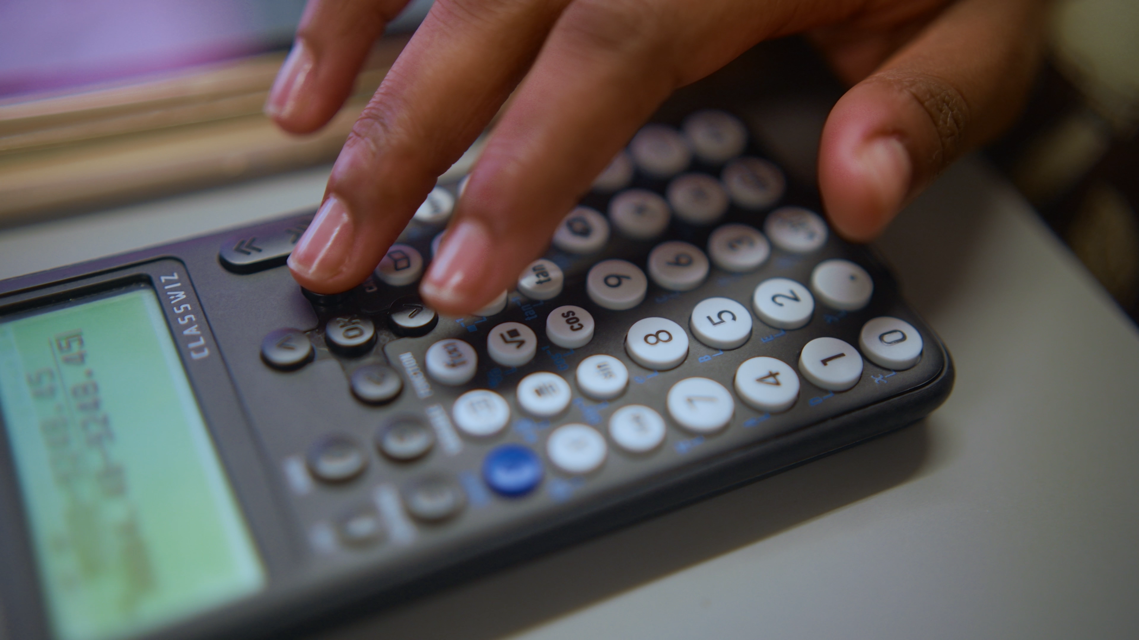Physics student using a calculator