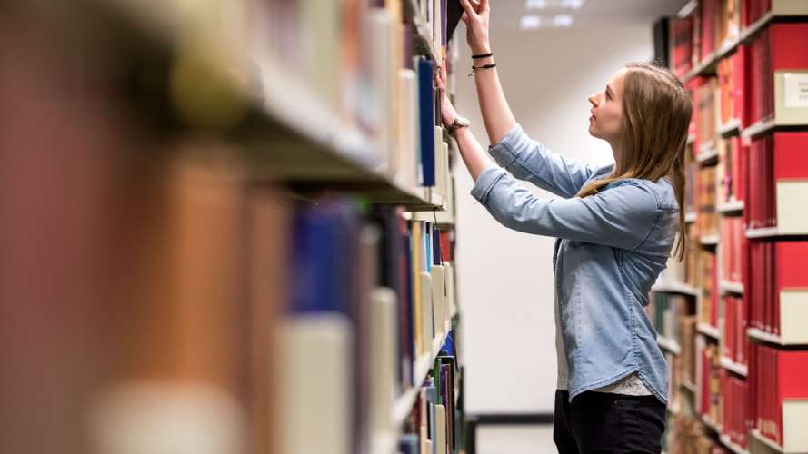 Students on campus in the Library