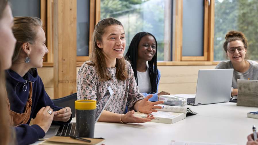students sitting around a table in discussion