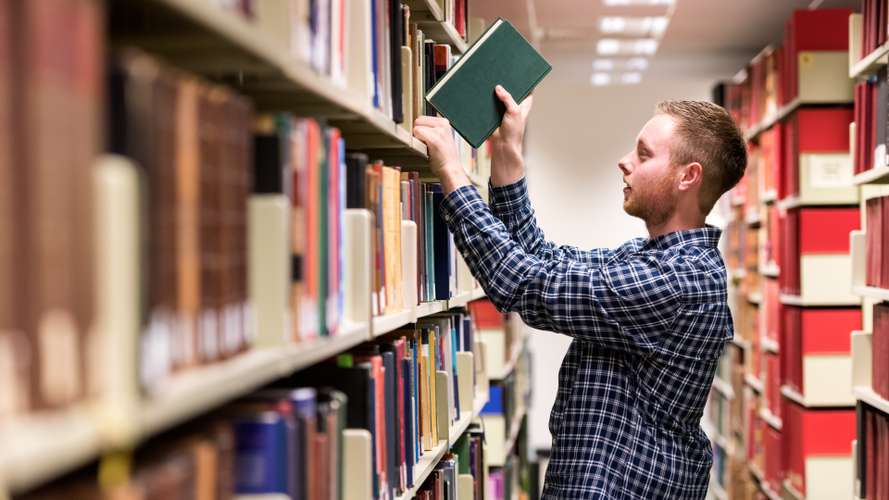 Students on campus in the Library