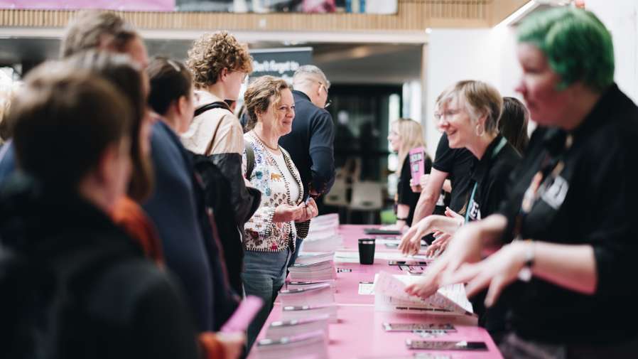 students and parents talking to university representative