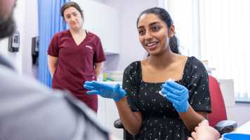Medicine student working with patient