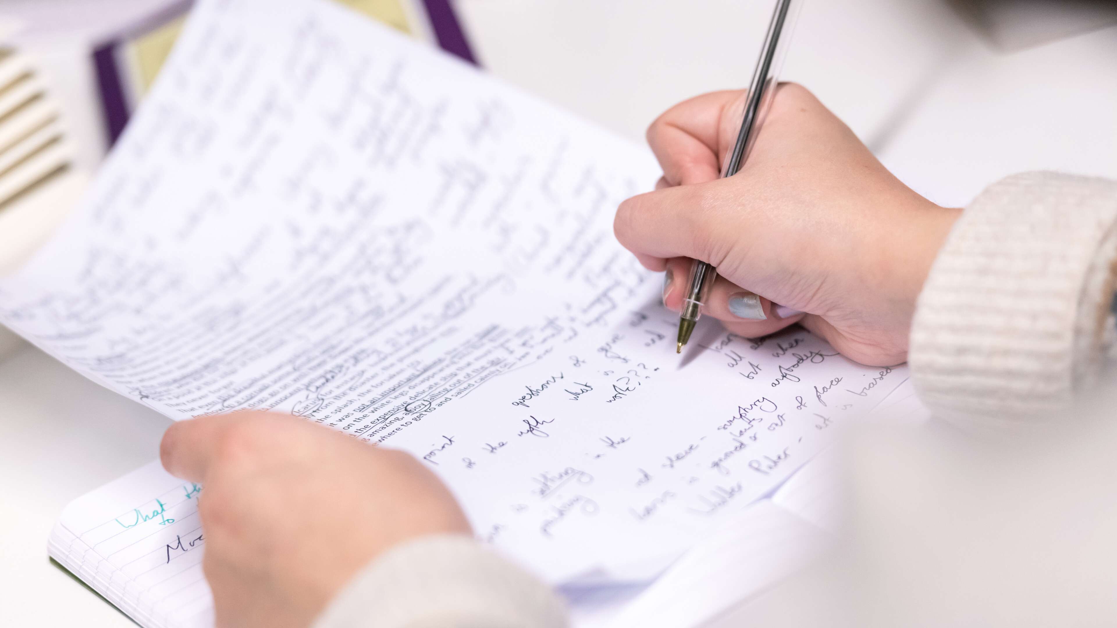 Student writing on a piece of paper