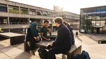 A group of students sitting and chatting in the Square