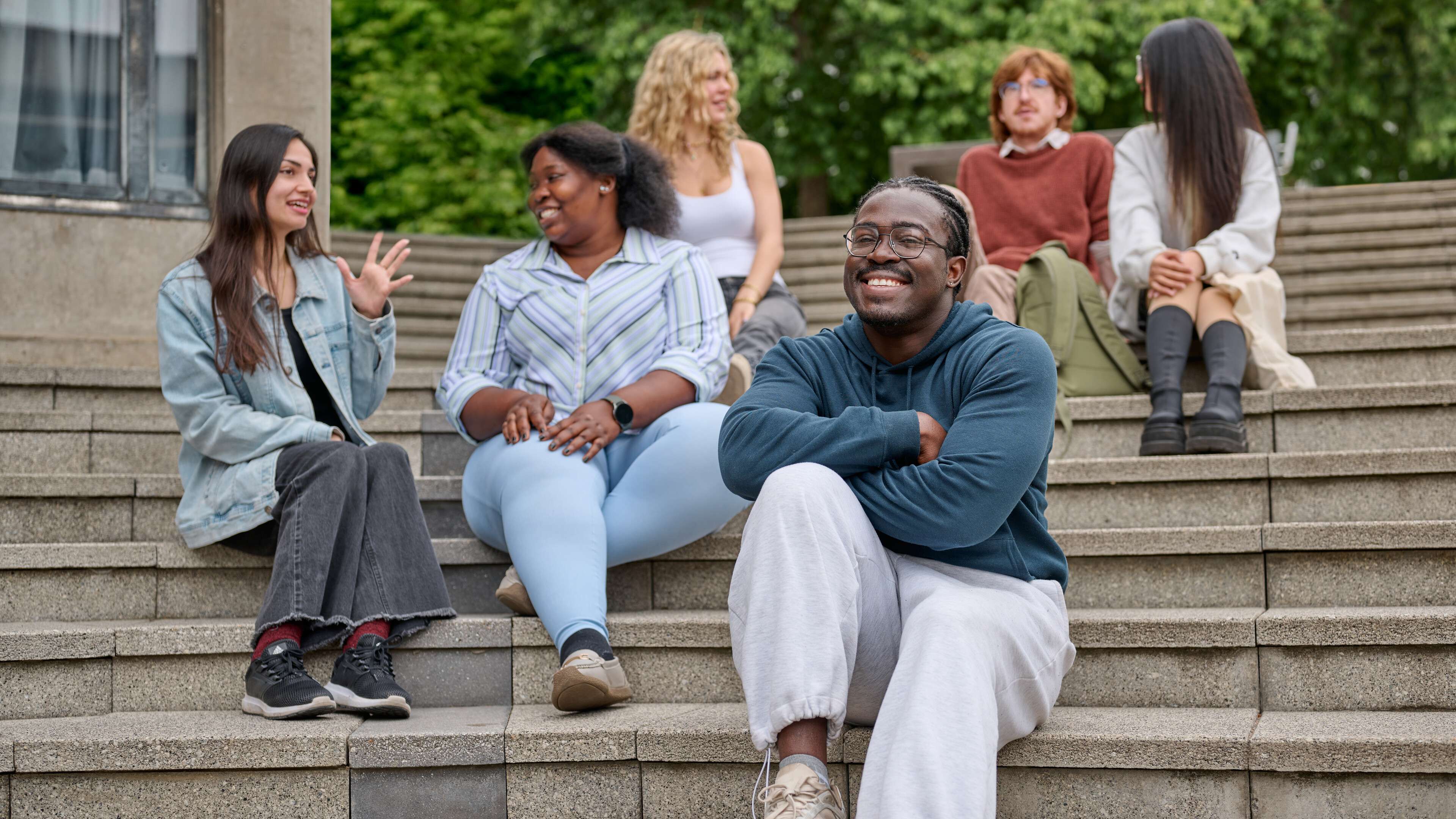 A group of students talking in the Square on the UEA campus