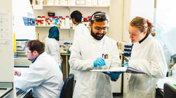 Biological science students working together in a laboratory