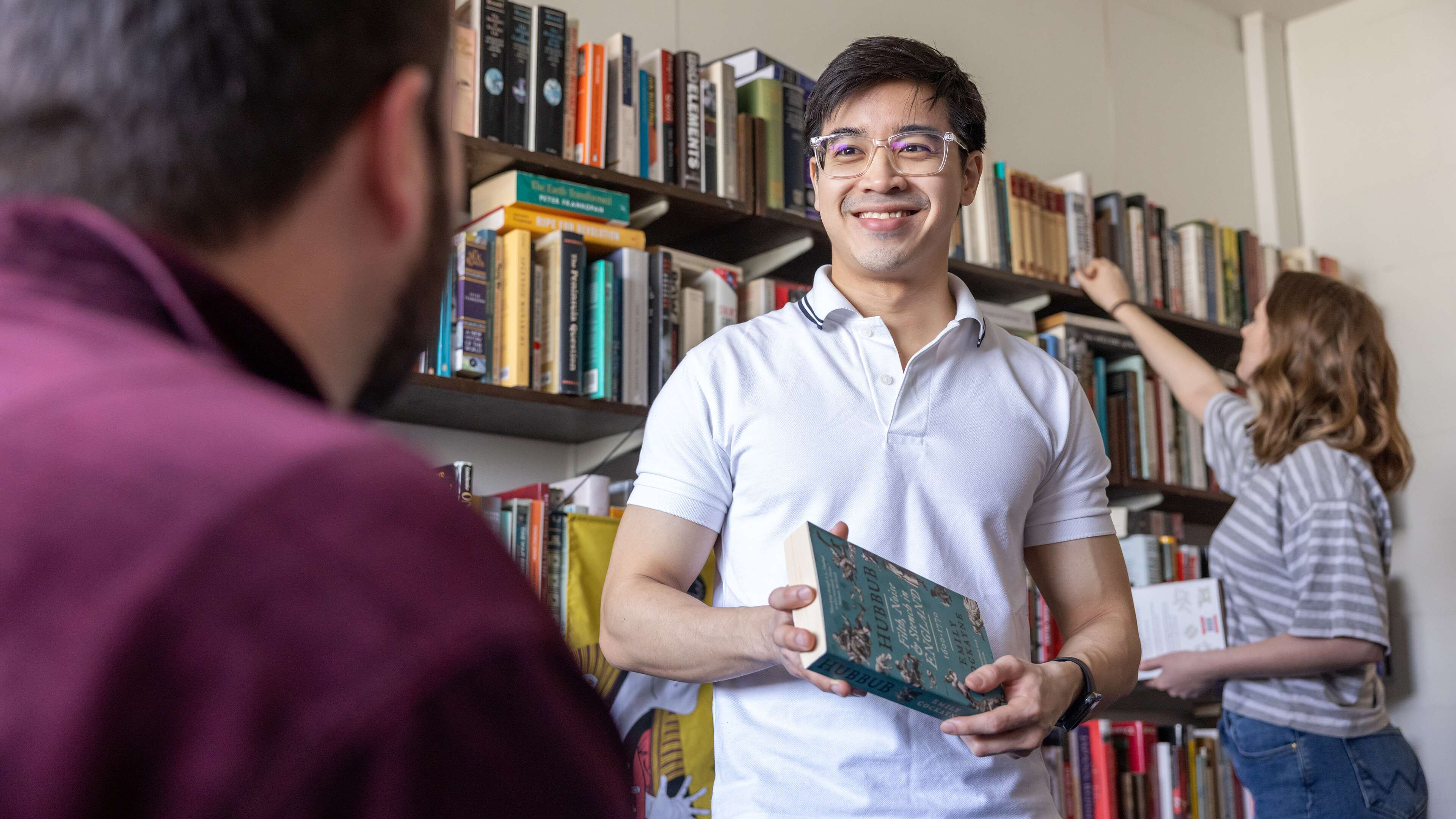 History students browsing books in an academic office
