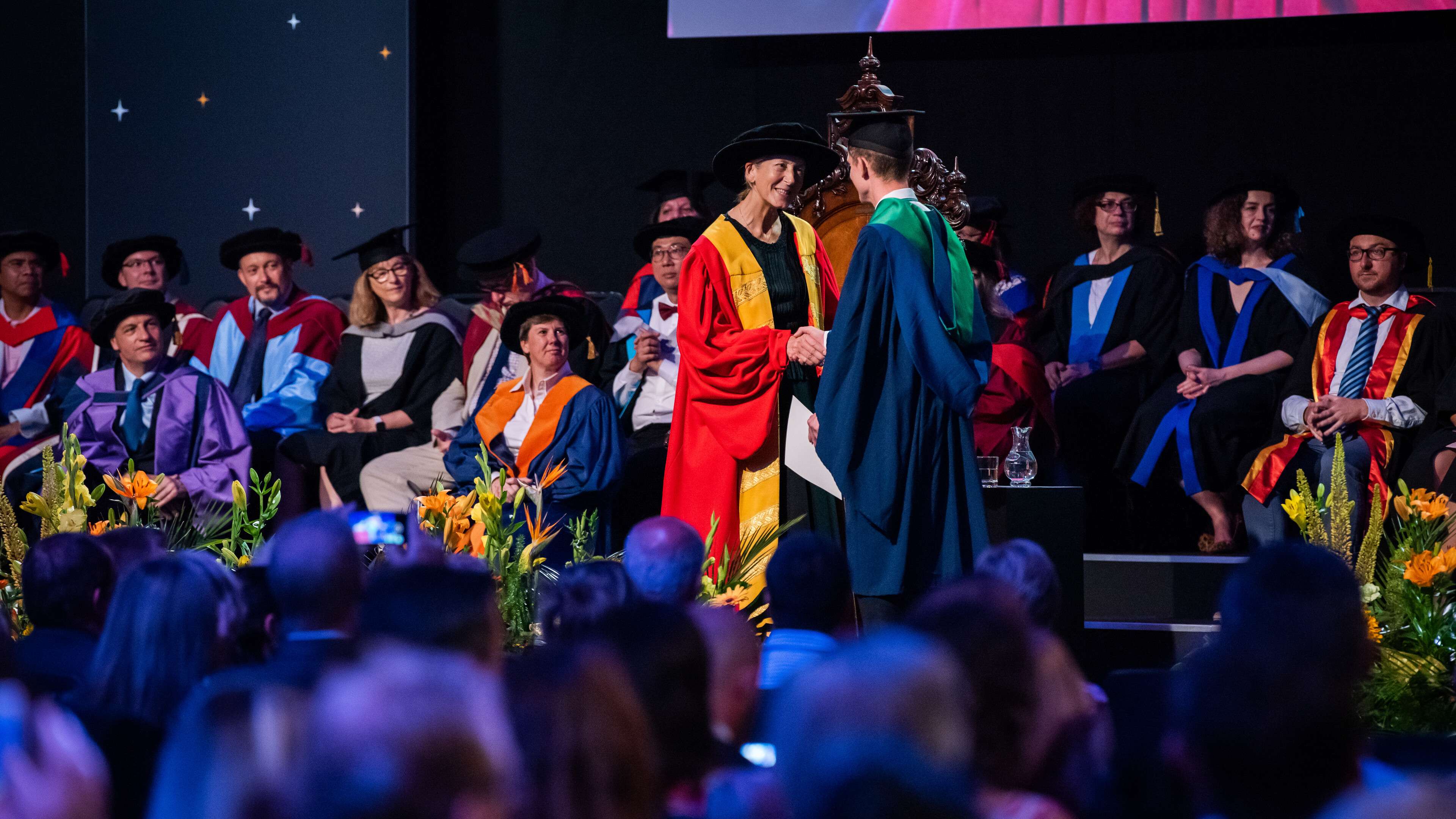 Students receiving their diplomas during their graduation ceremony