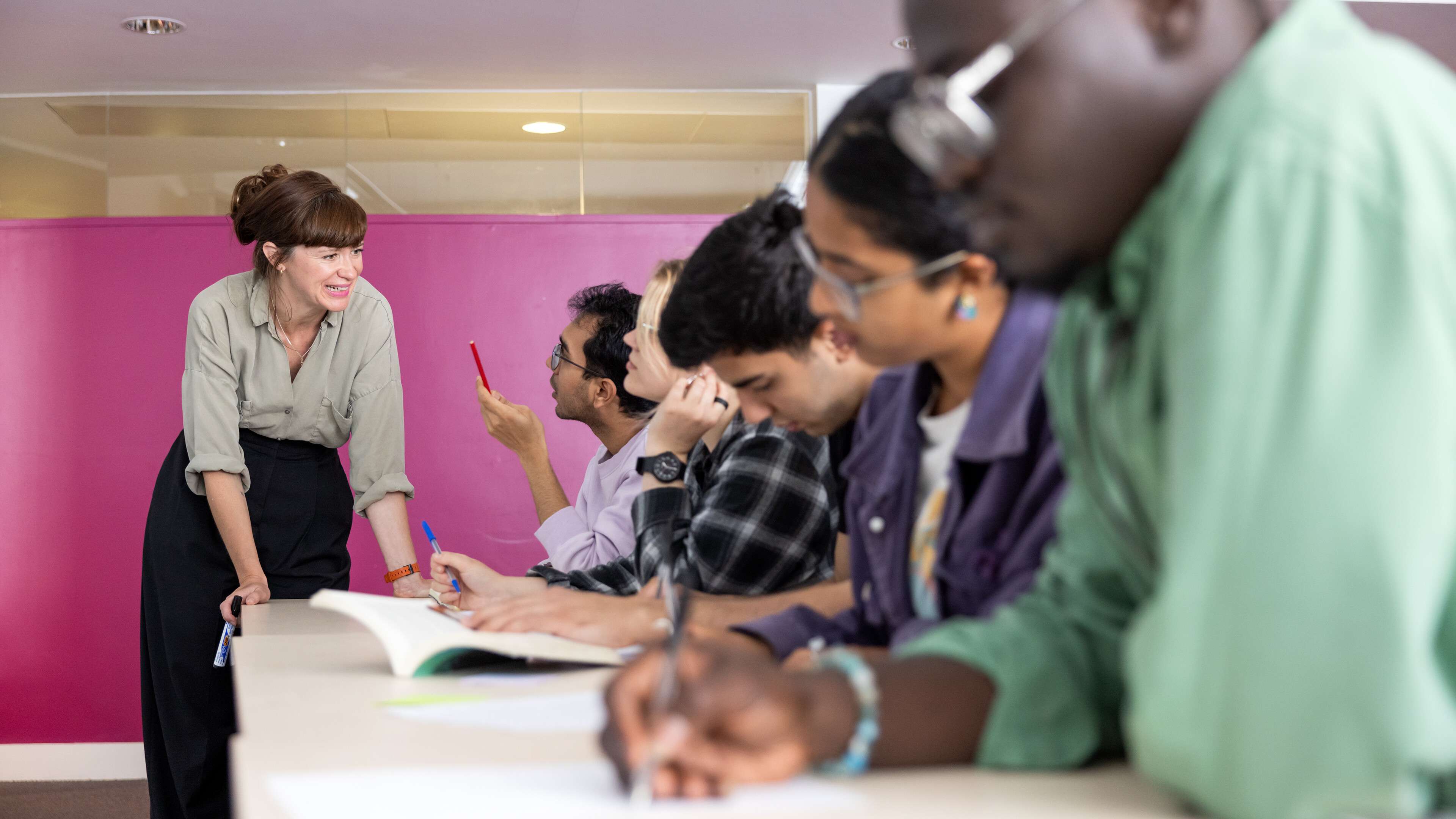 Tutor helping students in a seminar