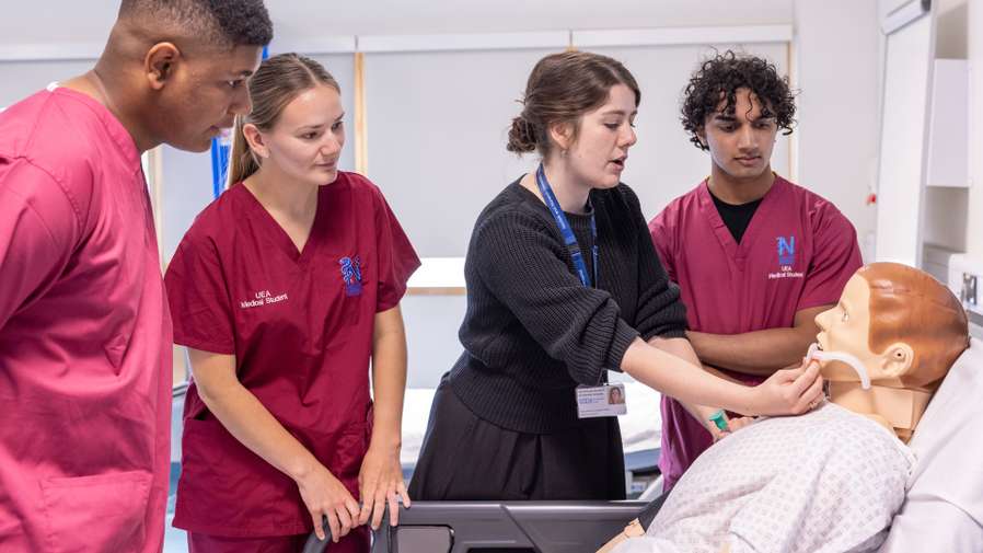 Medicine students working with a dummy