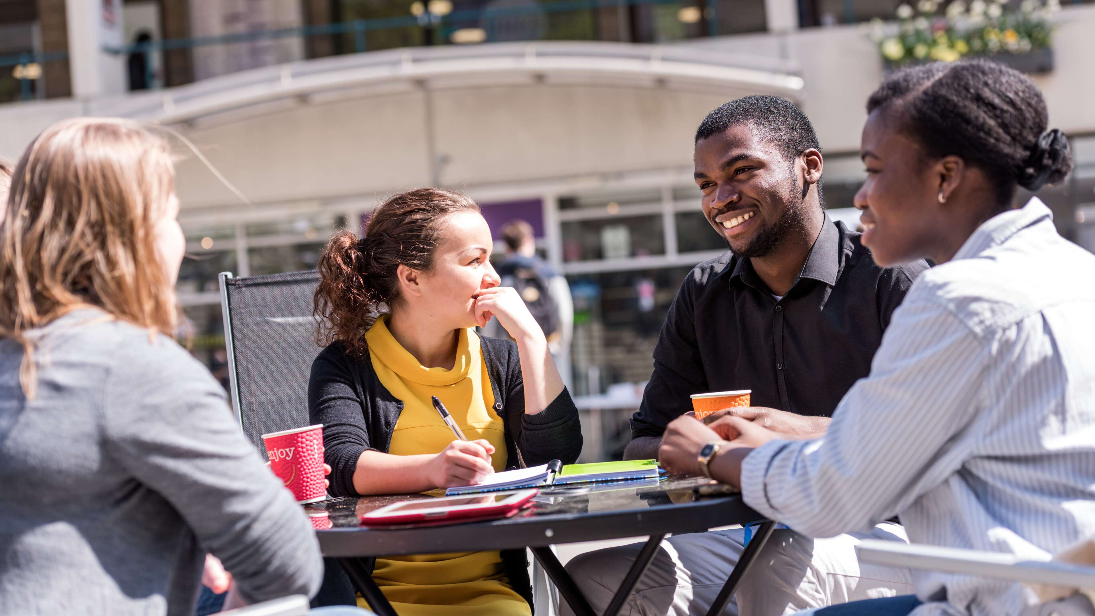Students sat at a table in the Square