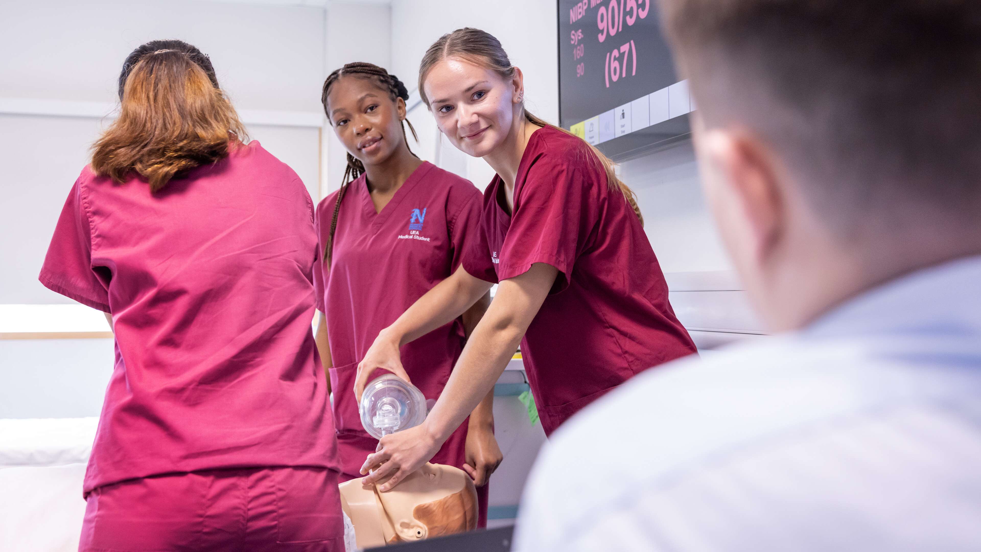 Medicine students working with a dummy