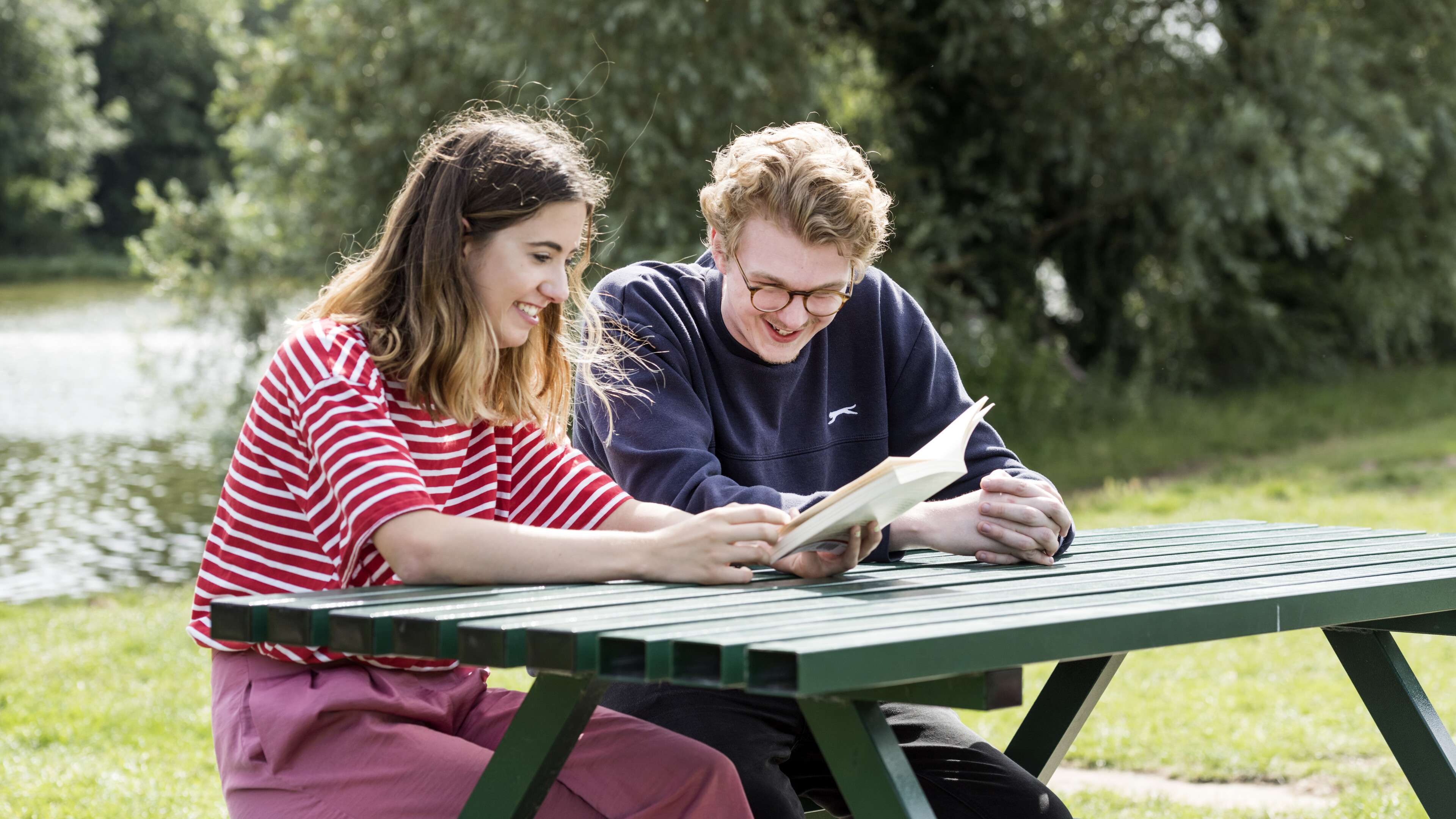 Two students studying by the UEA Broad