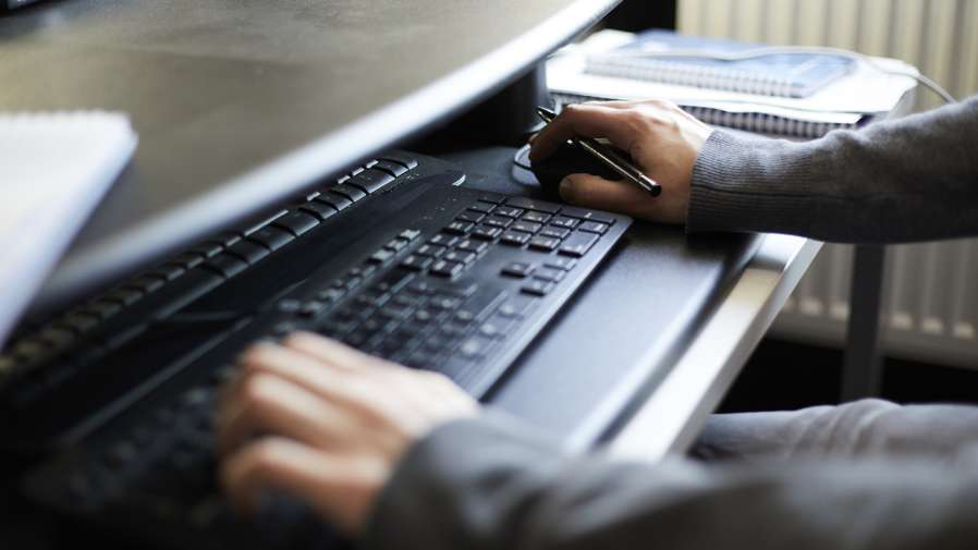 Estates Help Desk staff working on computer