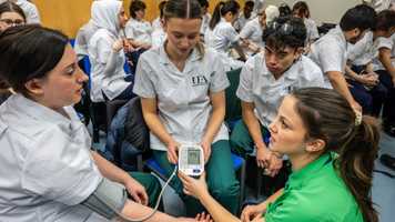 Physiotherapy students working together in a simulation session at Edith Cavell Building