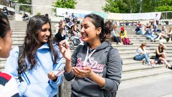Students laughing at the Square on UEA campus