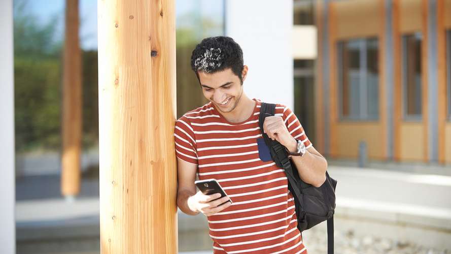 Student looking at phone outside the Enterprise Centre