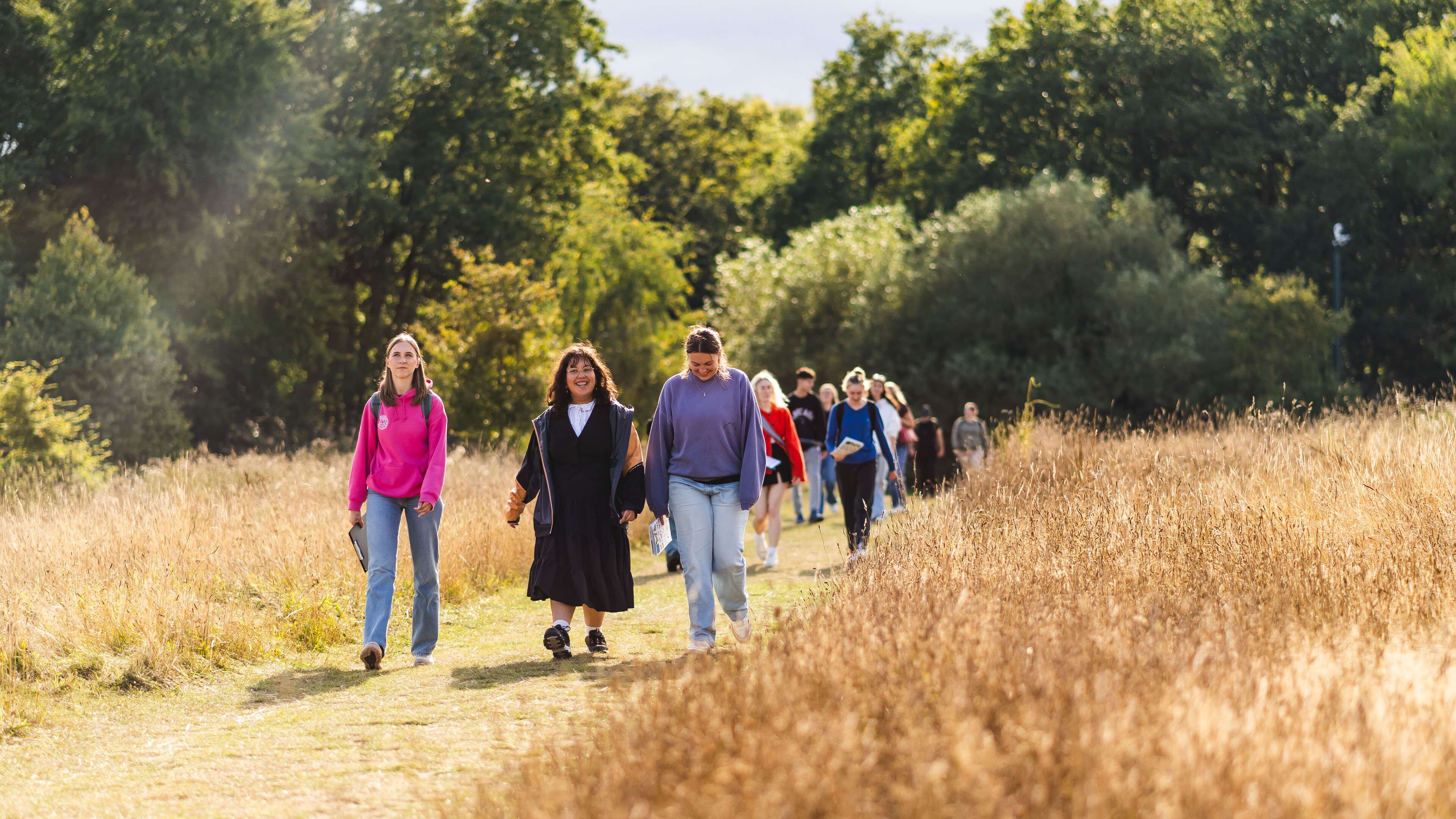 Environmental science and geography students on campus, taking part in an outdoor field activity.