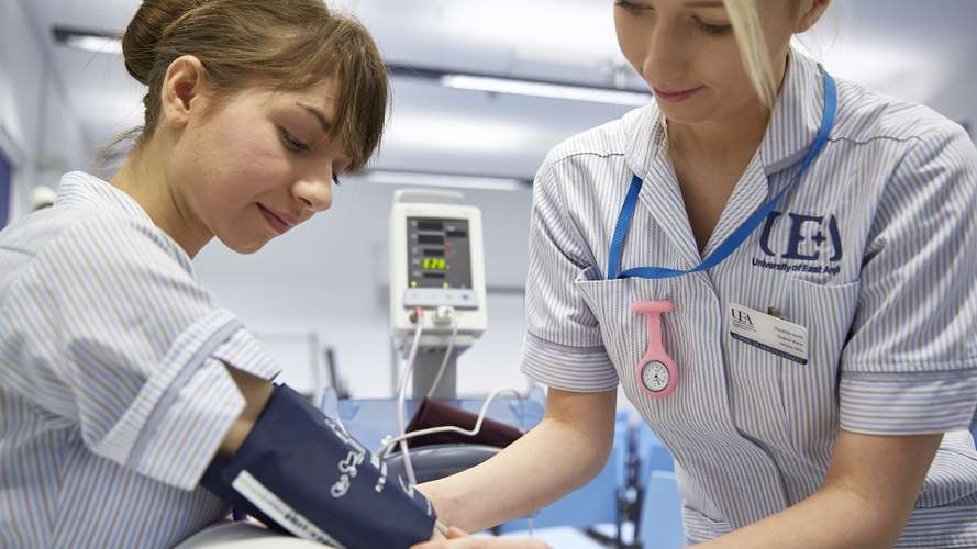 Nursing students taking blood pressure