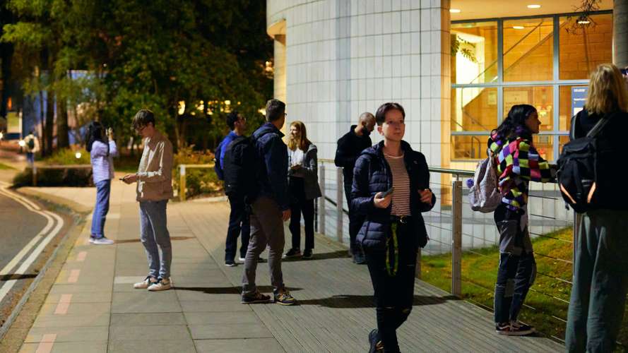Photo of students on campus at night