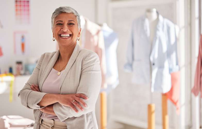 Woman posing in front of textile business