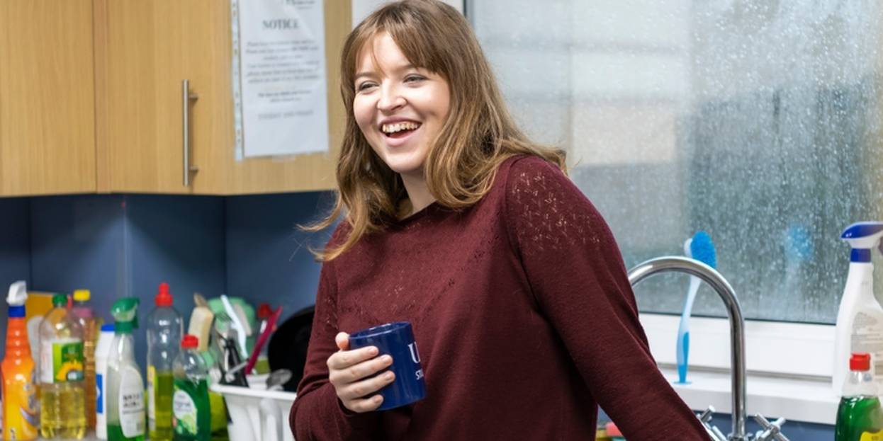 Ensuite Twin Yew House Student Smiling in Kitchen Holding Mug Gallery