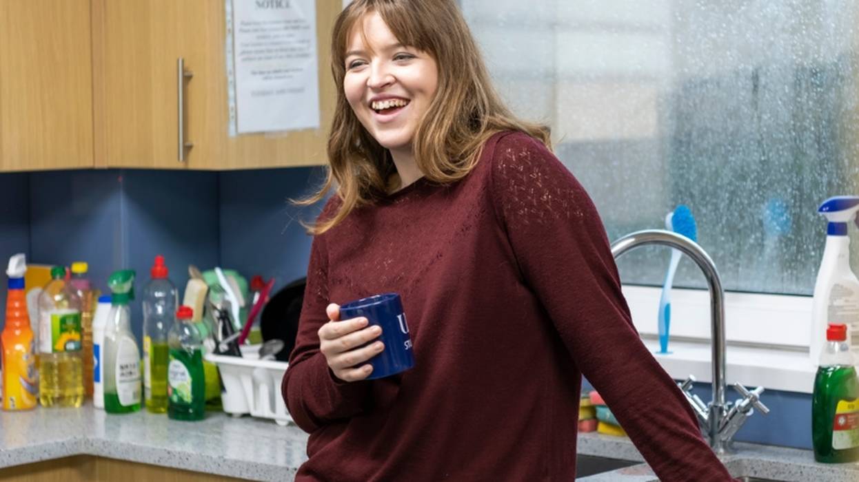 Ensuite Twin Yew House Student Smiling in Kitchen Holding Mug Gallery
