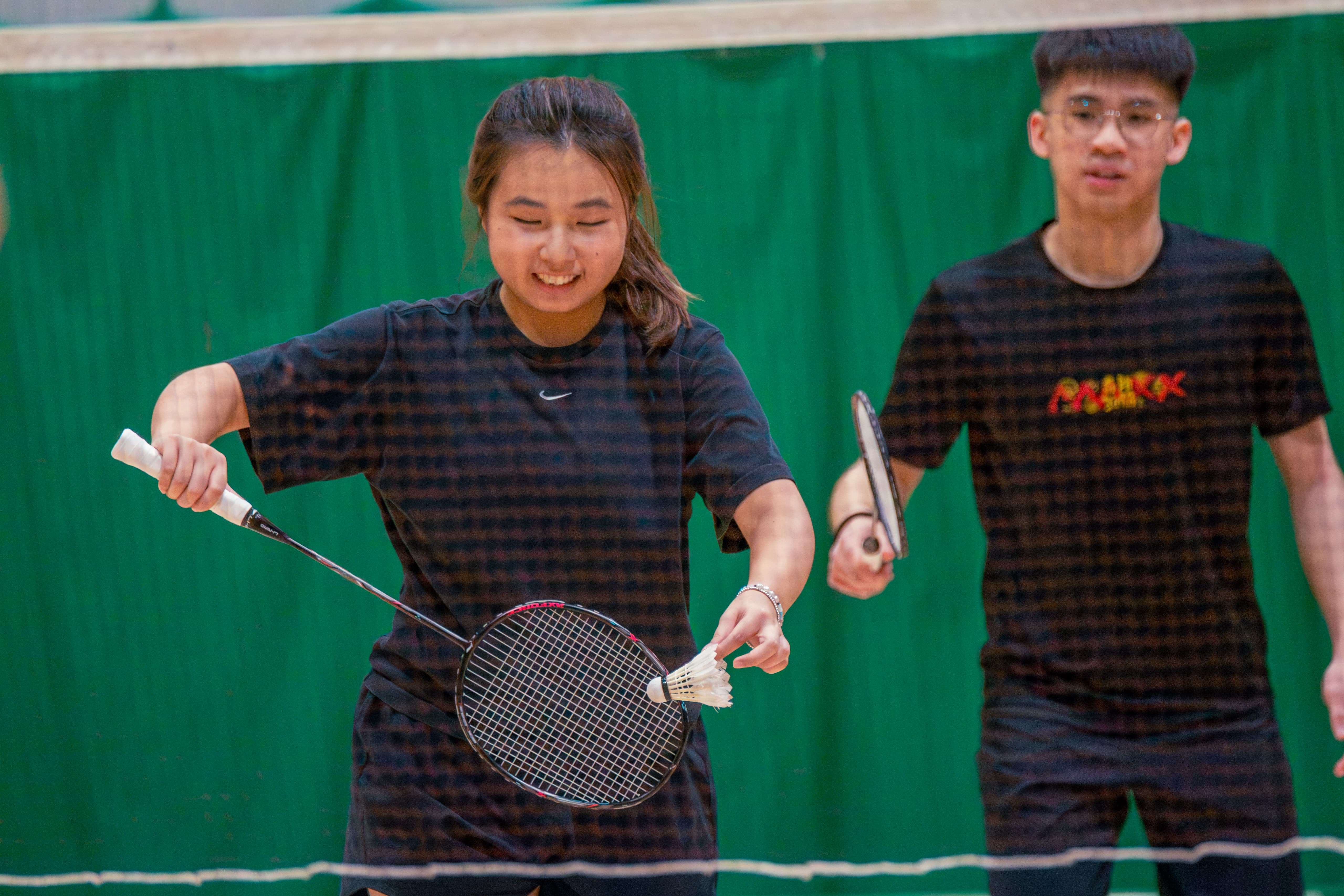 Two UEA students playing badminton.