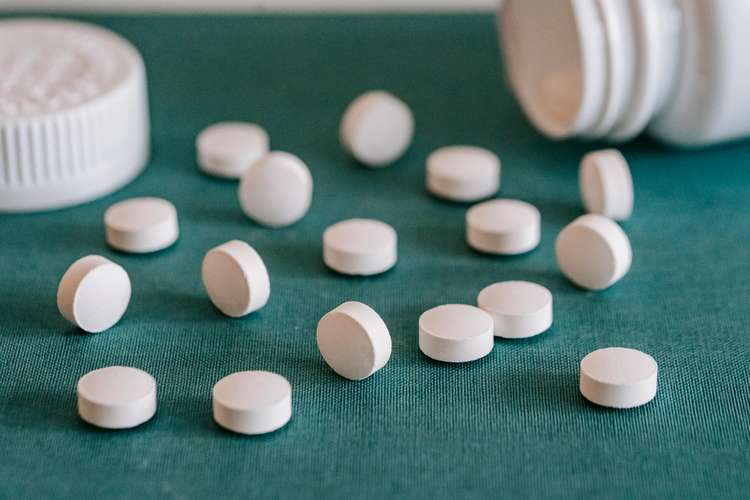 white tablets on a green surface