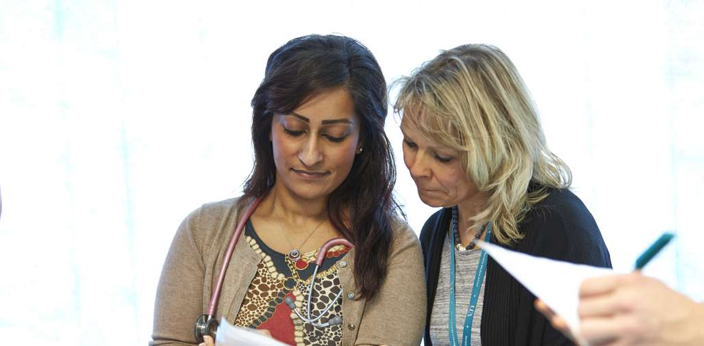 Medical student and mentor looking at assessment results