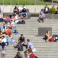 Two students in The Square on the UEA campus