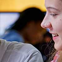 Two students sitting side by side working together